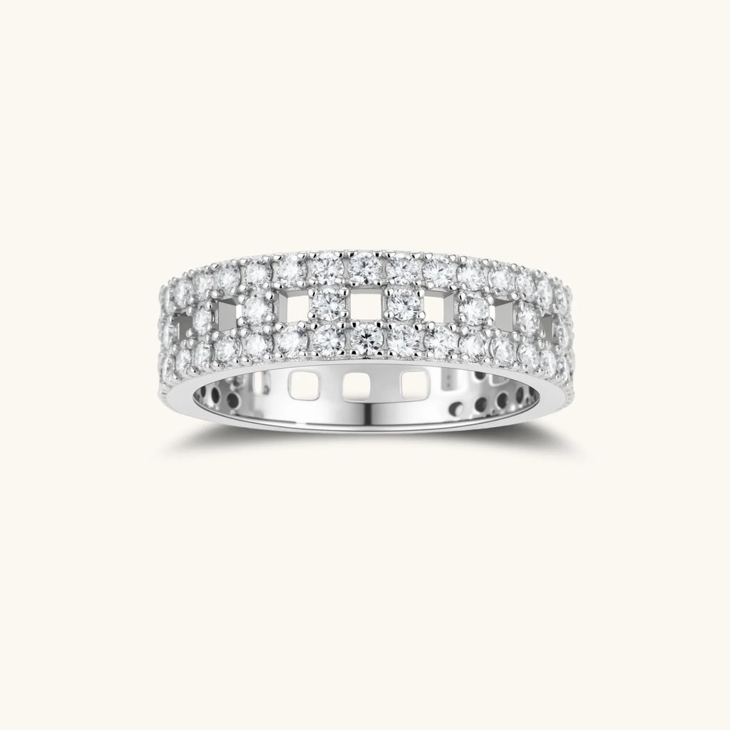 Wide sterling silver ring with three rows of brilliant moissanite stones in geometric pavé setting on white background