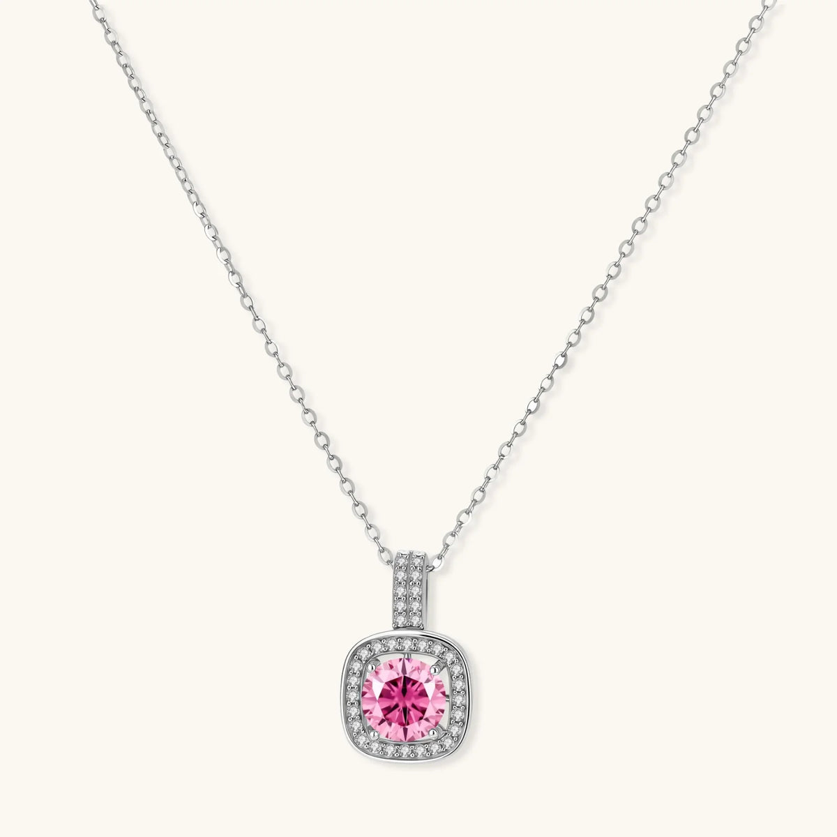 Sterling silver jewelry set featuring pink moissanite stones in halo settings on white background.