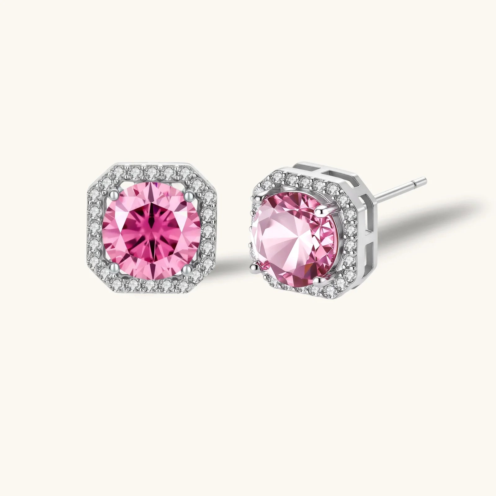 Sterling silver jewelry set featuring pink moissanite stones in halo settings on white background.