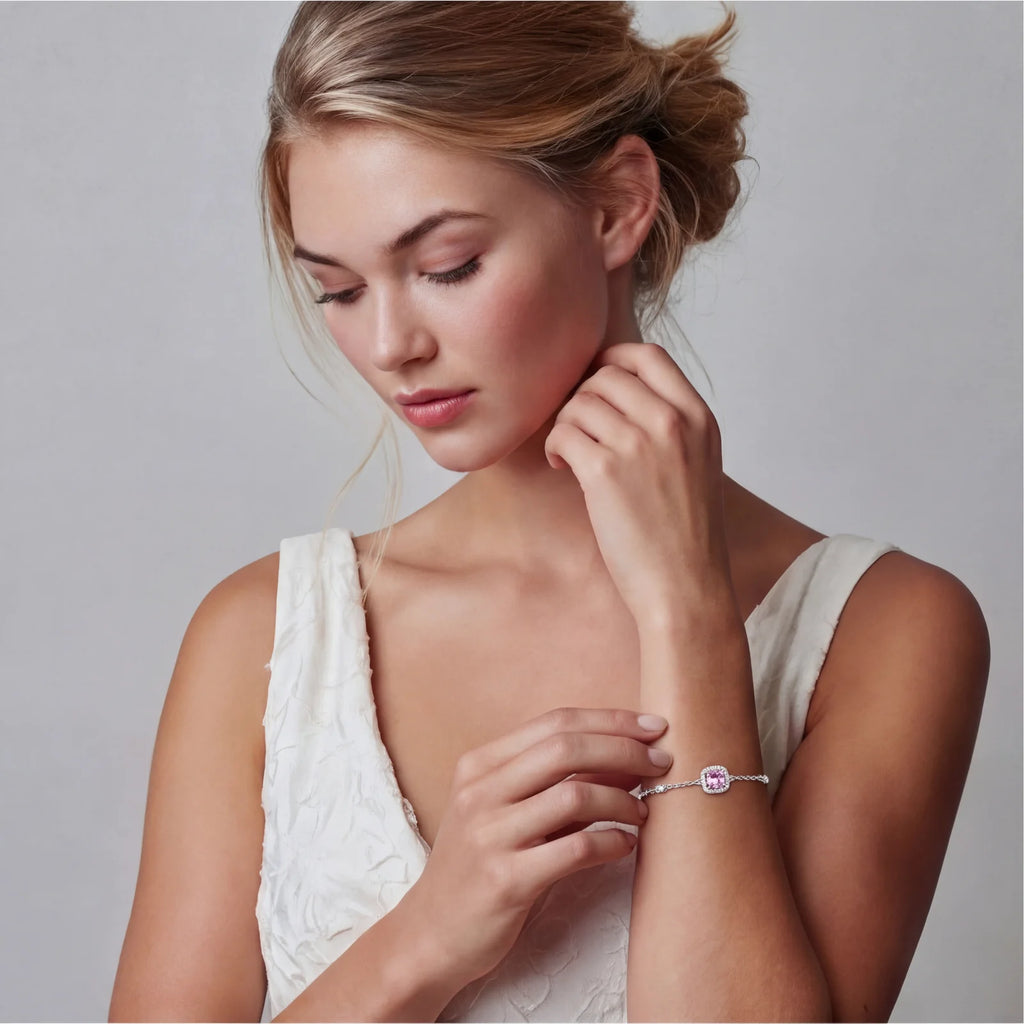 Sterling silver jewelry set featuring pink moissanite stones in halo settings on white background.